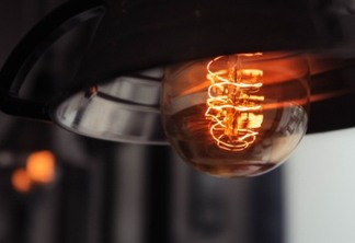 A closeup shot of a lit large lightbulb with a blurred background