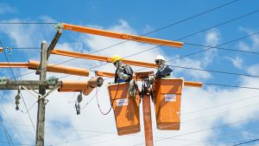 Eletricistas fazem reparo em rede de distribuição
